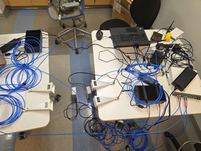 28 GHz wireless testbed with phased-array antennas, RF equipment, and a control laptop